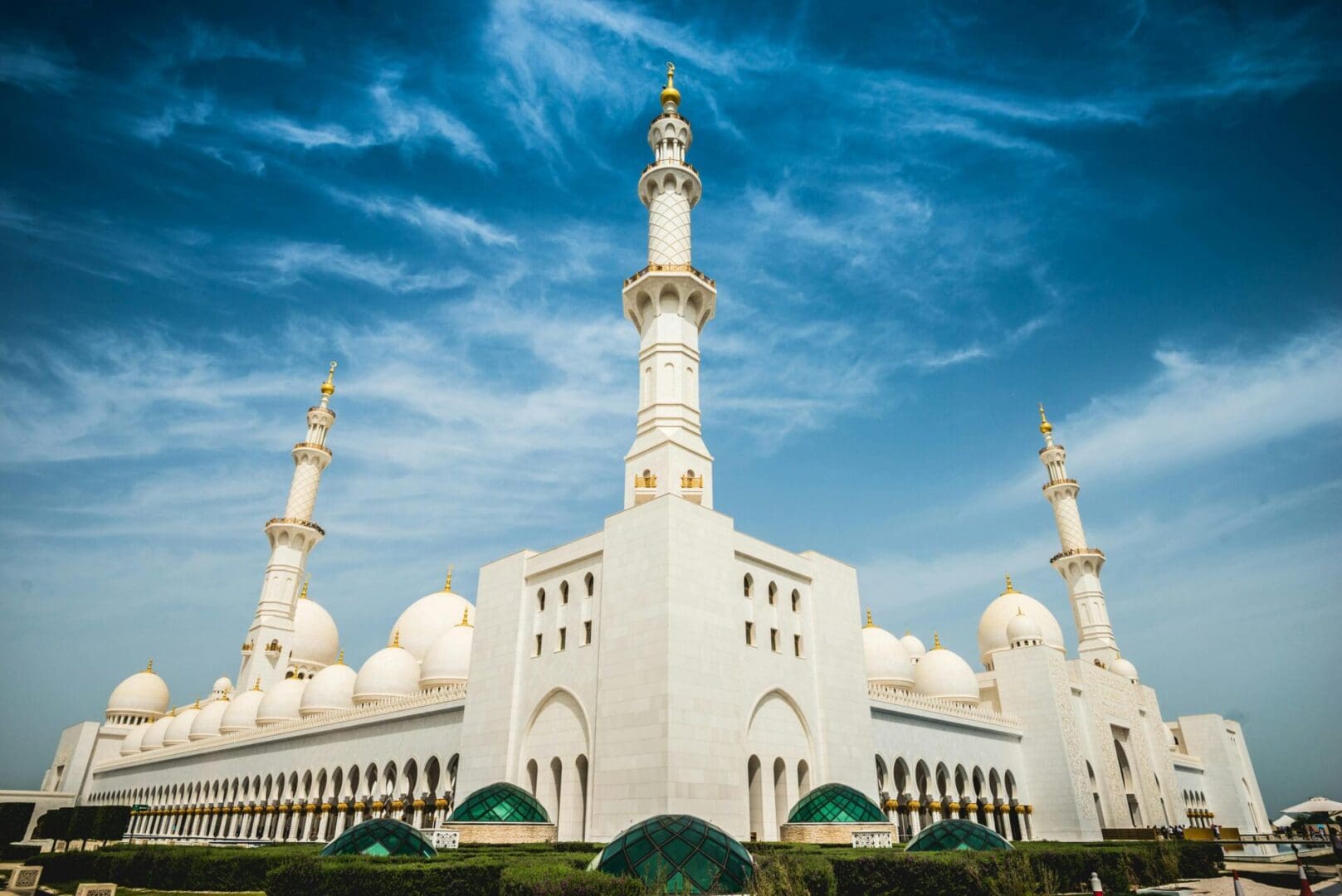 A large white building with many pillars and domes.