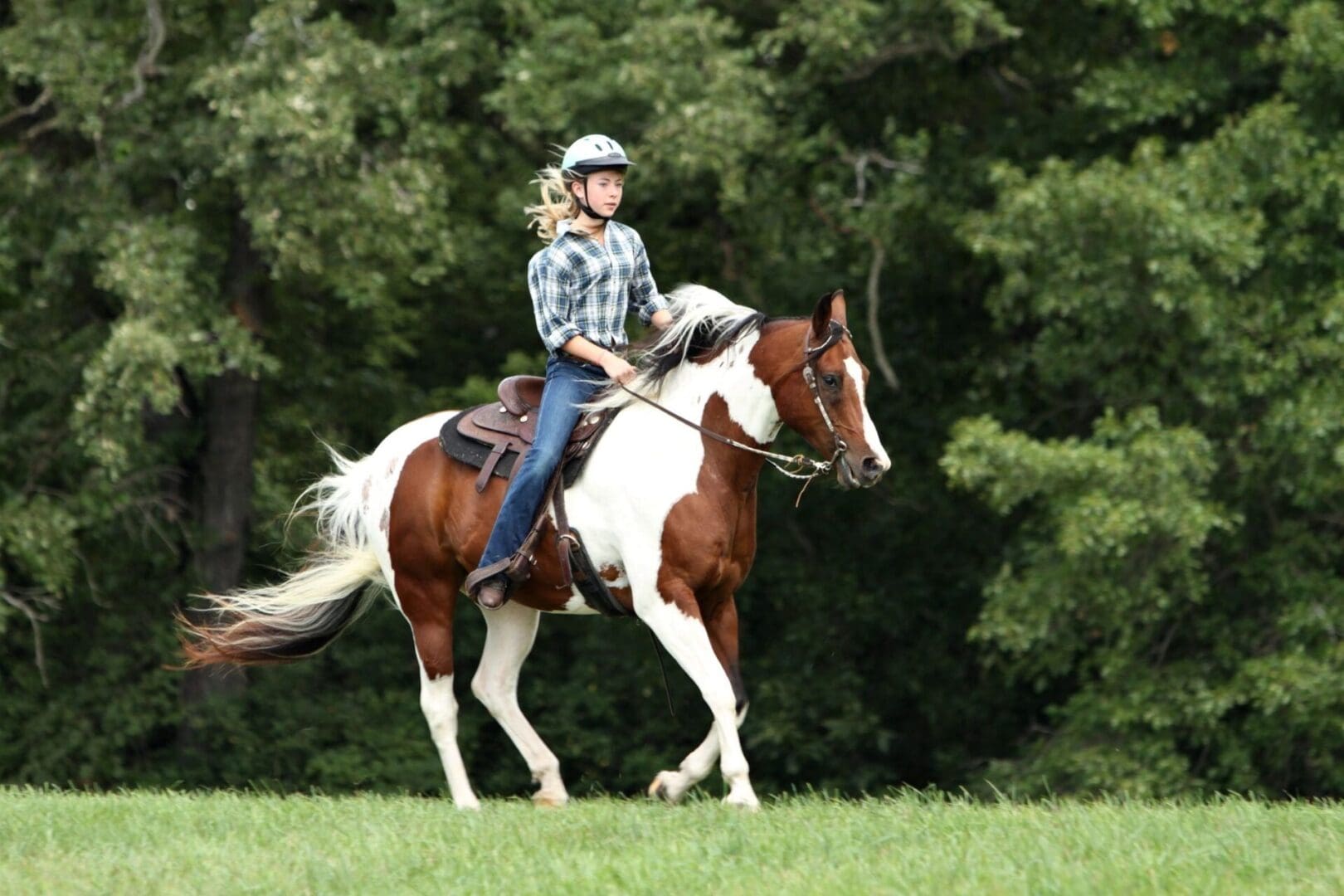 A woman riding on the back of a horse.