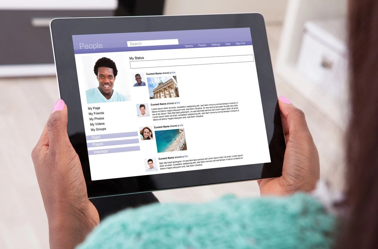 A person is holding an ipad with the screen on.